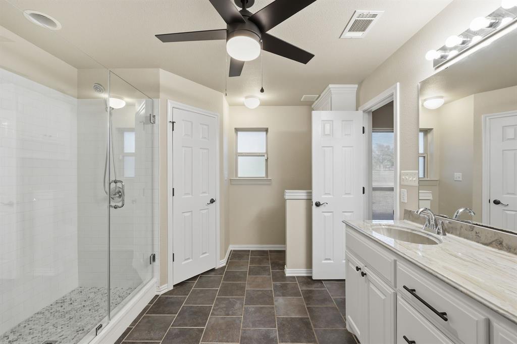 8875 Fm 2450 Sanger, TX 76266 - Photo 24 of 28 a bathroom with a shower sink and mirror