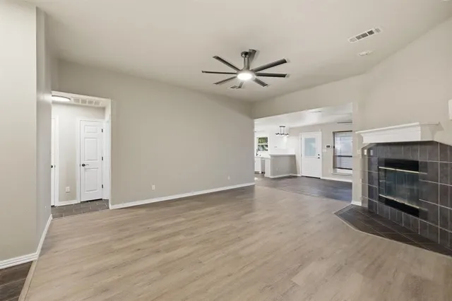a view of a livingroom with a fireplace and window