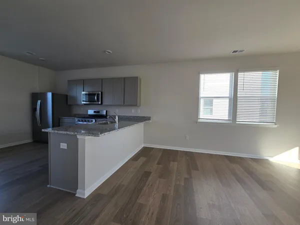 a kitchen with wooden floors and white appliances