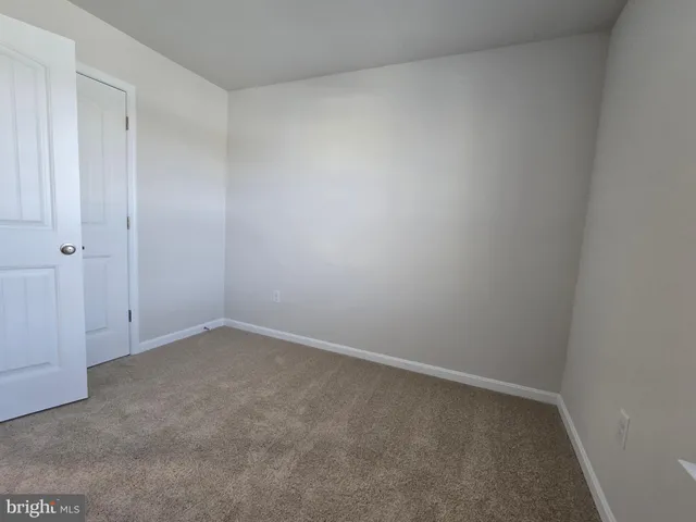 a view of a hallway with bathroom and sink