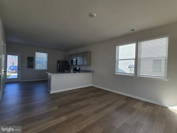 a view of a living room a window and wooden floor