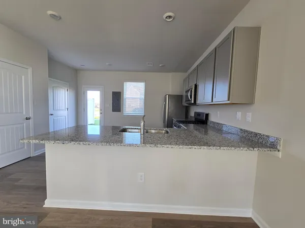 a view of a kitchen with granite countertop cabinets