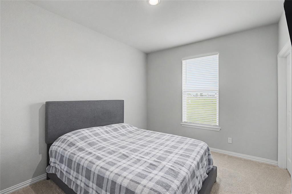185 Chester Road Springtown, TX 76082 - Photo 27 of 40 Carpeted room featuring a single window with blinds, light gray walls, and white baseboards