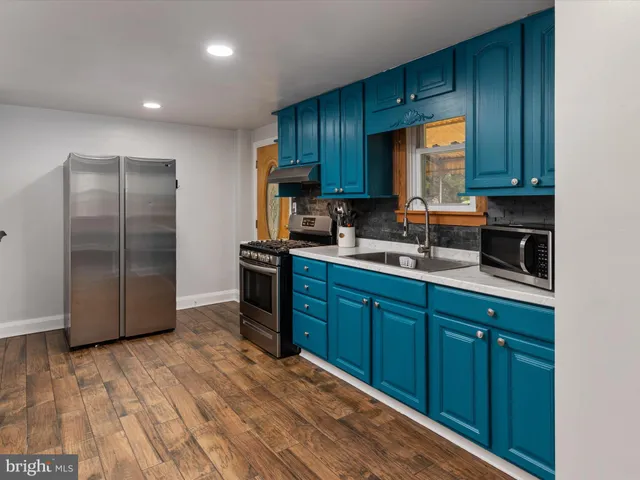 a kitchen with wooden cabinets and a sink