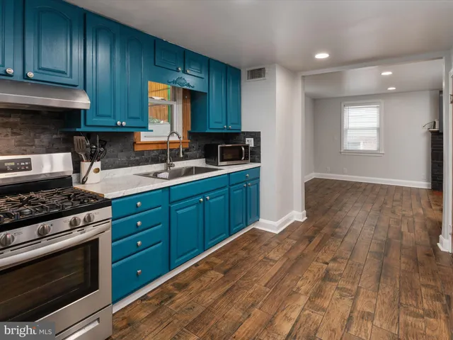 a kitchen with wooden floors and a stove