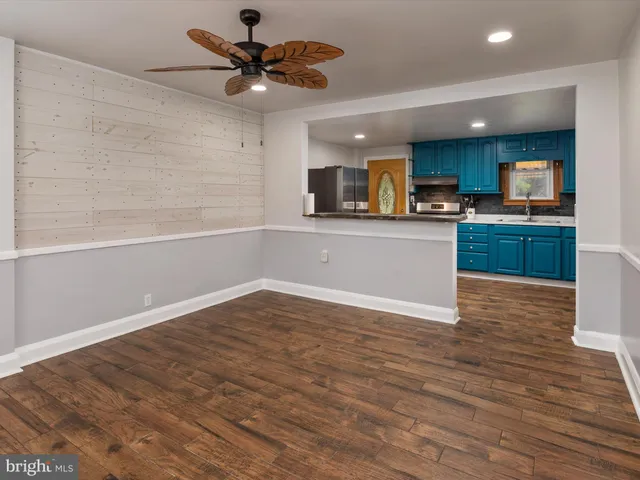 a view of kitchen with sink microwave and stove top oven