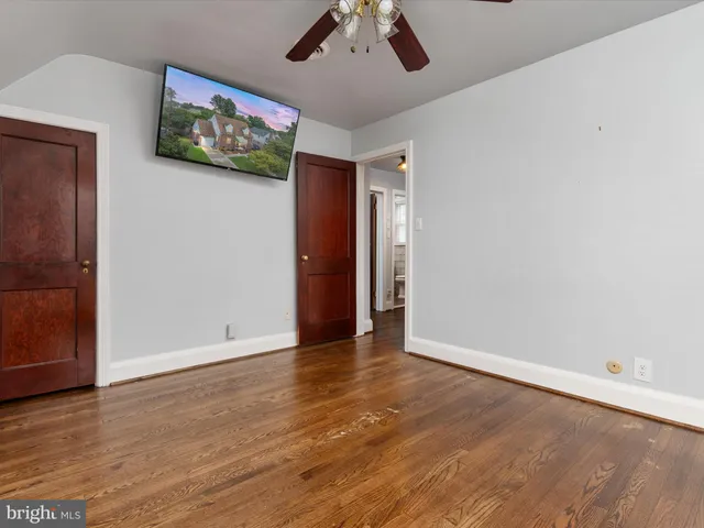 a view of an empty room with wooden floor