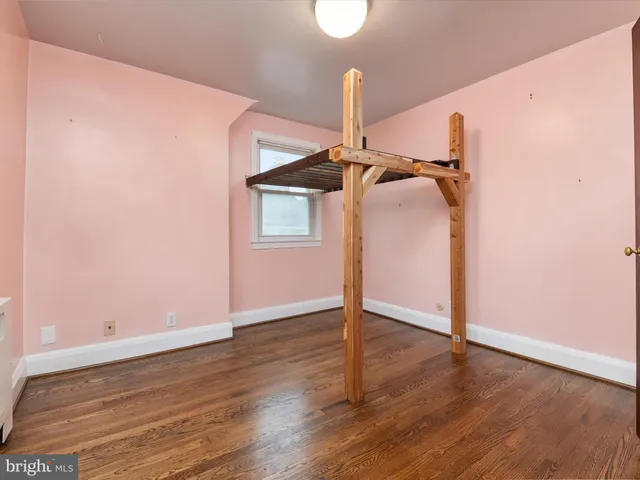 an empty room with wooden floor and closet