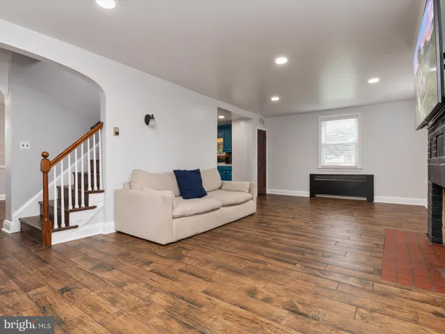 a living room with furniture and a kitchen view