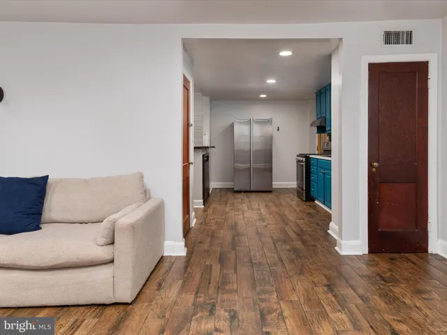 a living room with a couch and a dresser