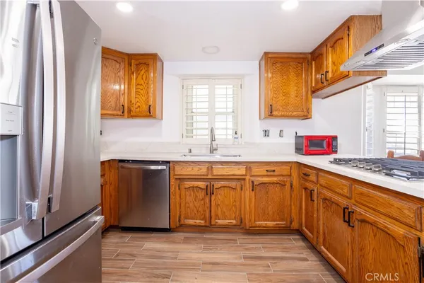 a kitchen with stainless steel appliances granite countertop a sink stove and cabinets