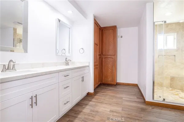 a spacious bathroom with a double vanity sink and mirror
