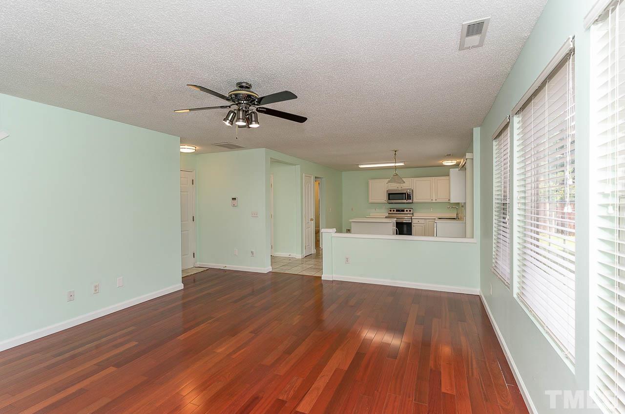 5601 Orchard Gate Way Raleigh, NC 27616 - Photo 14 of 28 a view of a big room with wooden floor a ceiling fan and windows
