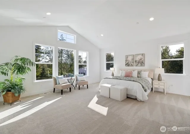 a spacious bathroom with a large tub sink and window