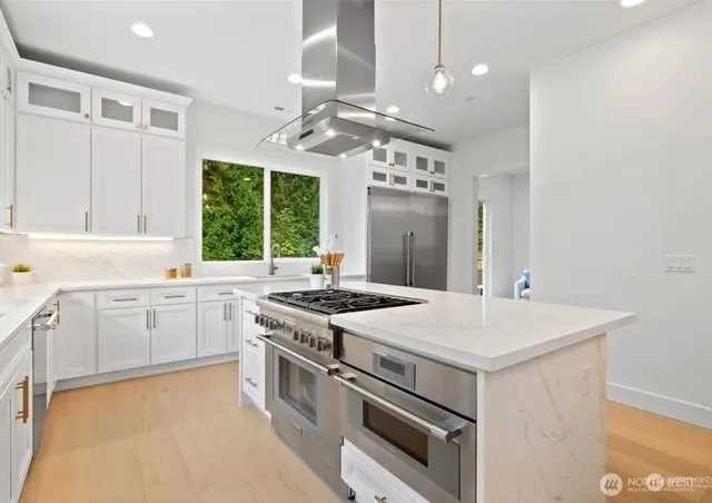 a kitchen with a dining table chairs sink and granite counter tops