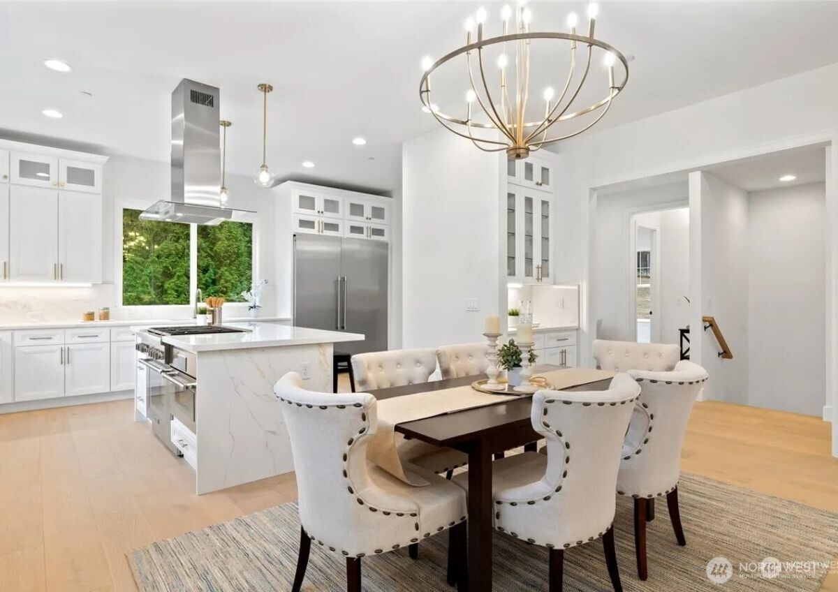 15410 Northeast 103rd Way Redmond, WA 98052 - Photo 8 of 20 a kitchen with a dining table chairs sink and granite counter tops