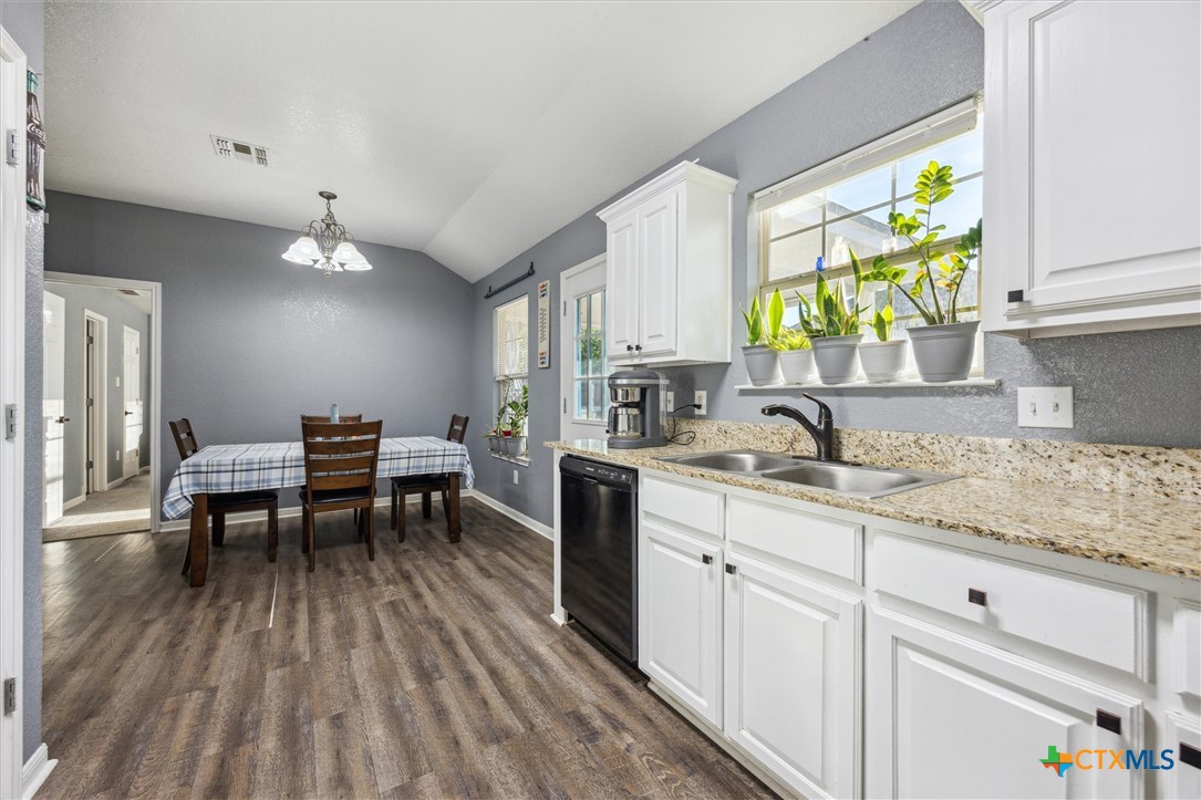 1220 Redstone Drive Temple, TX 76502 - Photo 15 of 35 a kitchen with sink cabinets and wooden floor