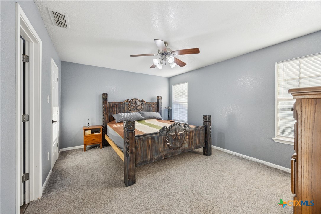 1220 Redstone Drive Temple, TX 76502 - Photo 16 of 35 a bed room with a bed and a chandelier