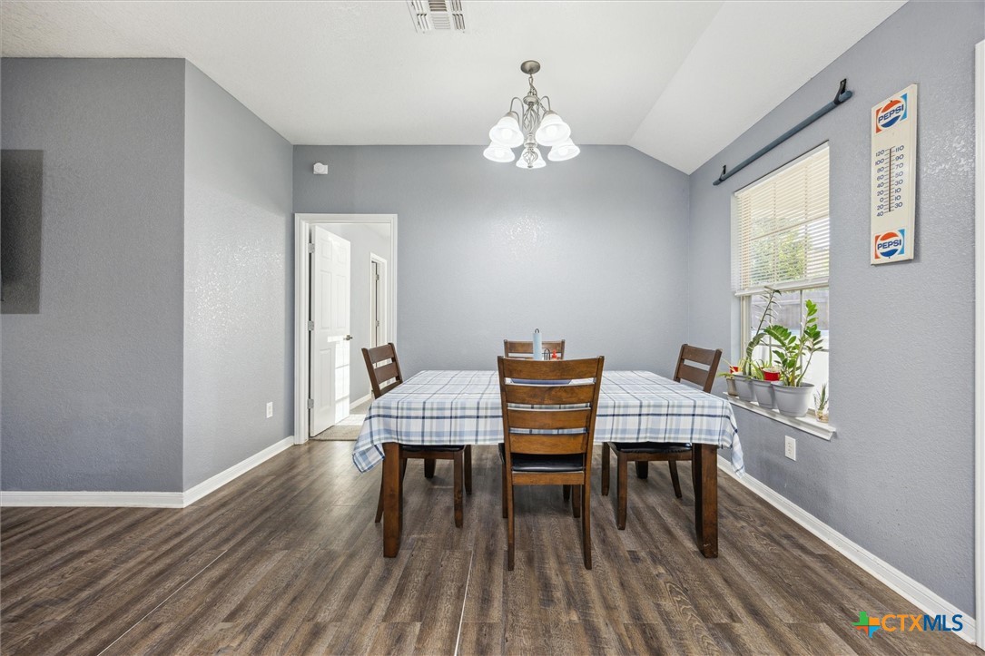 1220 Redstone Drive Temple, TX 76502 - Photo 7 of 35 a dining room with furniture a chandelier and wooden floor