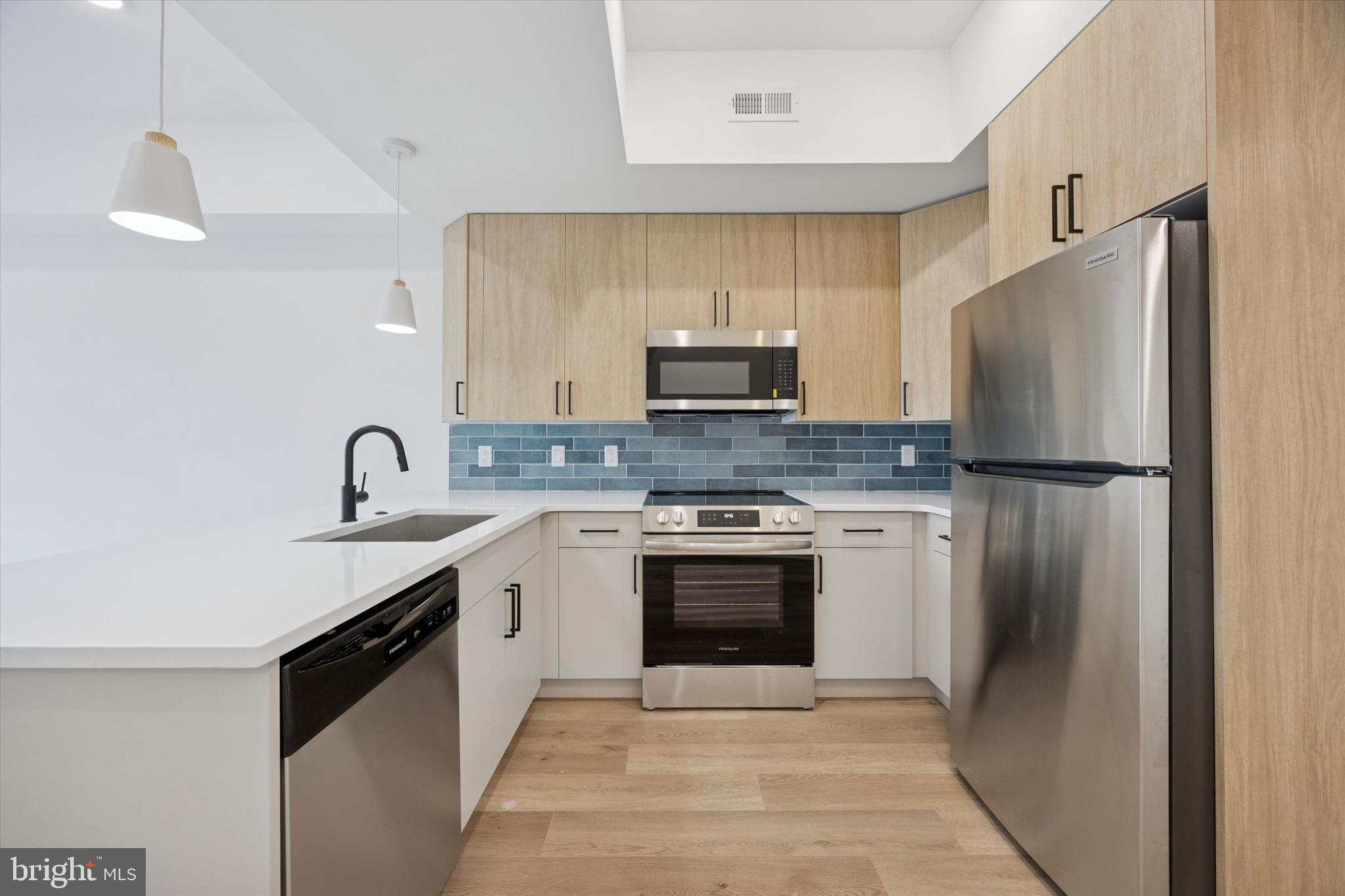 2020 Frankford Avenue, Unit 201 Philadelphia, PA 19125 - Photo 4 of 14 a kitchen with a sink stainless steel appliances and cabinets