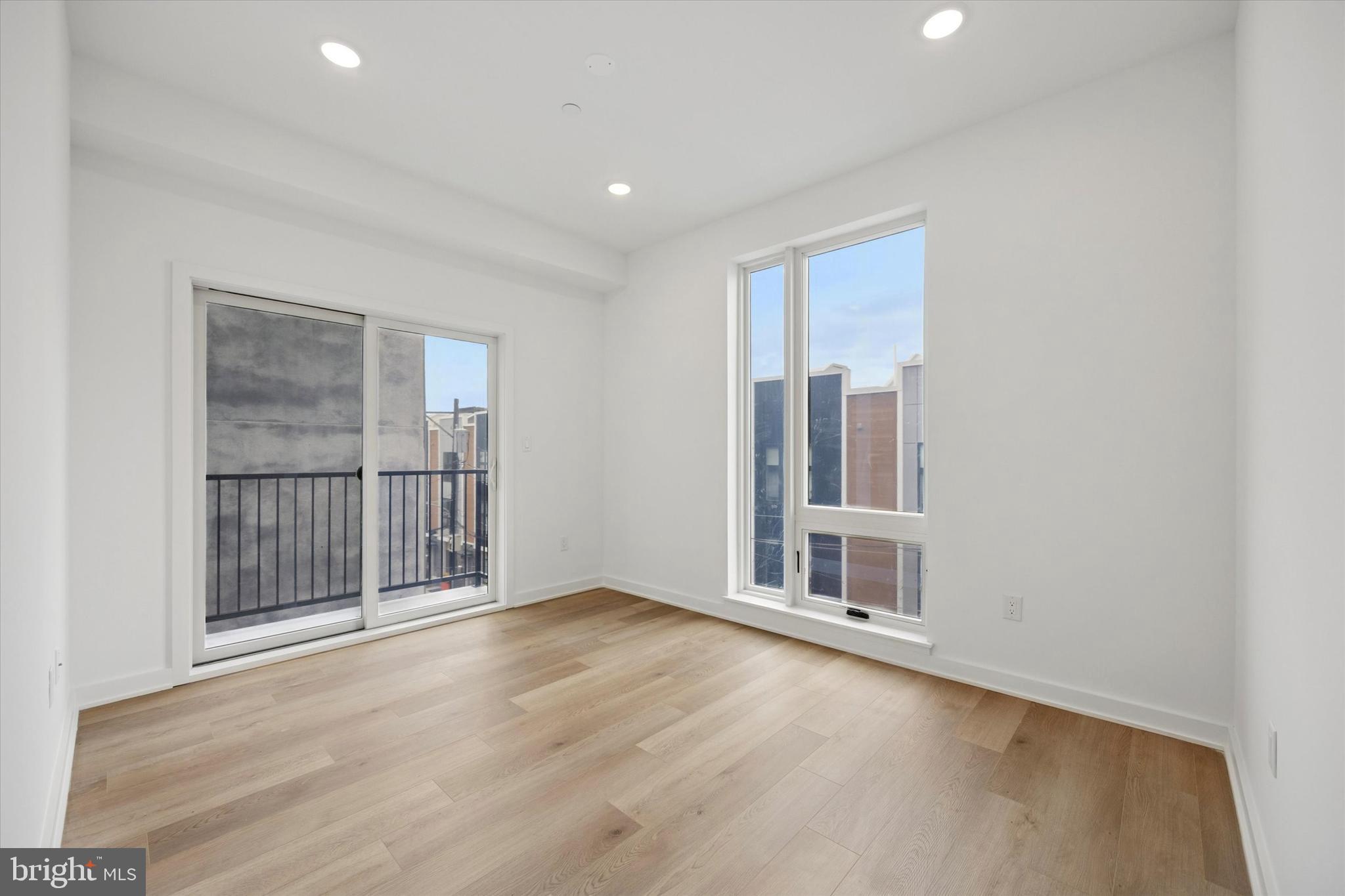 2020 Frankford Avenue, Unit 201 Philadelphia, PA 19125 - Photo 7 of 14 a view of an empty room with wooden floor and fan