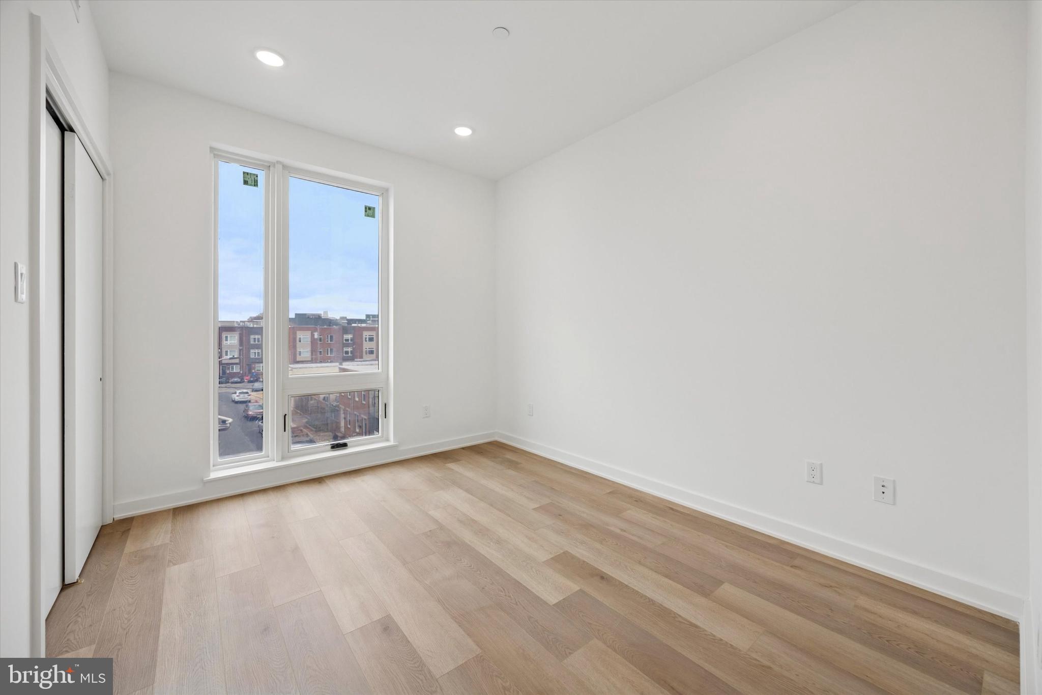 2020 Frankford Avenue, Unit 201 Philadelphia, PA 19125 - Photo 10 of 14 an empty room with wooden floor and windows