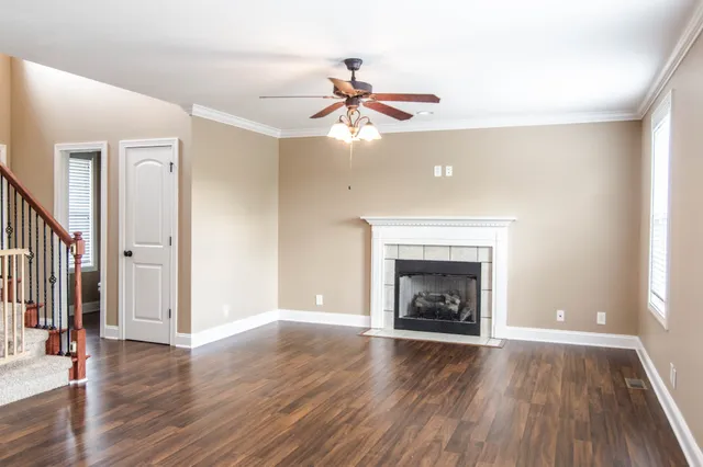 a view of a livingroom with a fireplace and wooden floor
