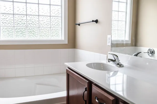 a bathroom with a bathtub and a sink