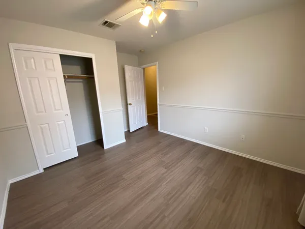 a kitchen with granite countertop a stove a sink and a refrigerator