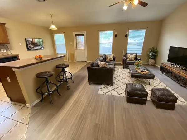 a kitchen with granite countertop a stove a microwave and a sink