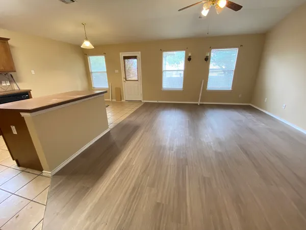a kitchen with a sink a window cabinets and stainless steel appliances