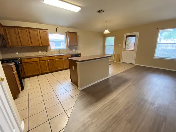 a kitchen with stainless steel appliances a sink and a cabinets