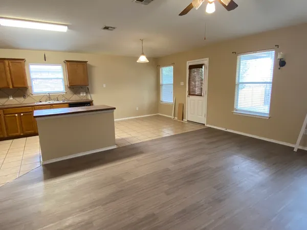 a view of kitchen with granite countertop cabinets and wooden floor