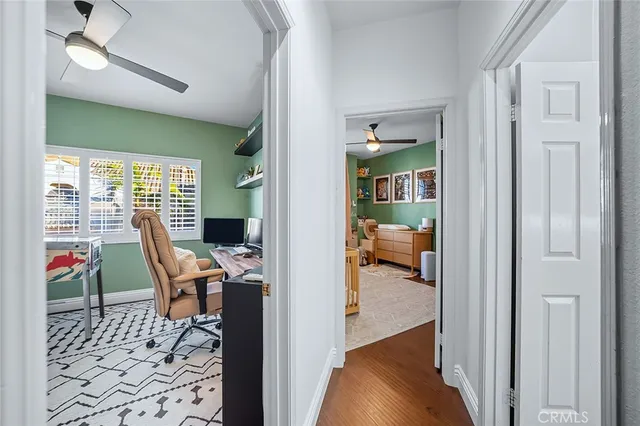 a bedroom with furniture a rug and a fan
