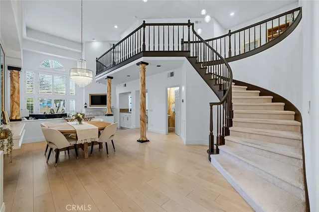 a living room with furniture a large window and a table