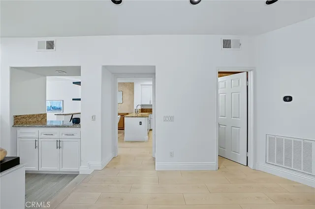 a kitchen with stainless steel appliances granite countertop a sink refrigerator and cabinets