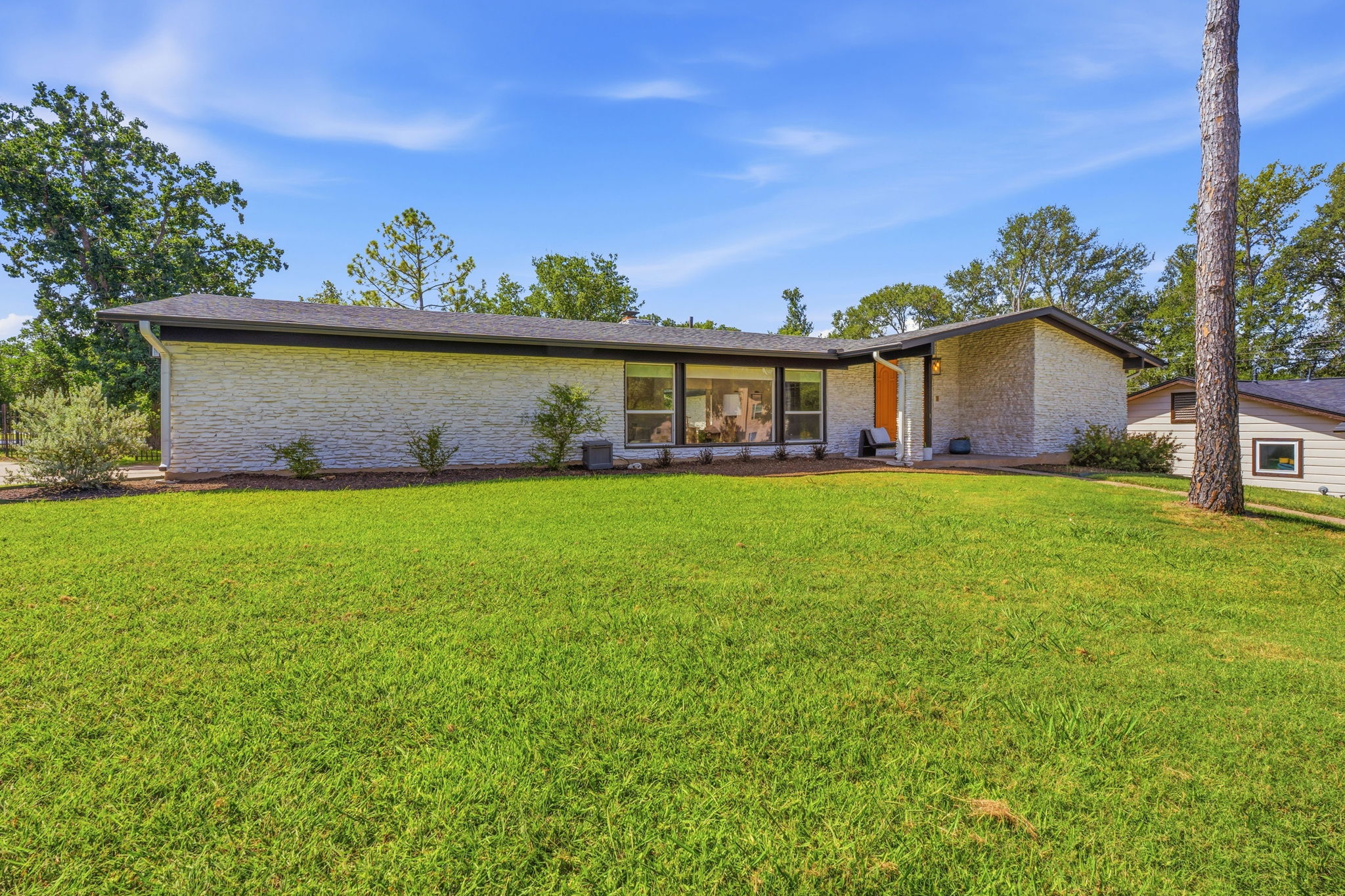 4403 Elmsgrove Drive Austin, TX 78721 - Photo 1 of 38 A well-maintained lawn welcomes you to this distinctive home with a sleek, low-profile roof.