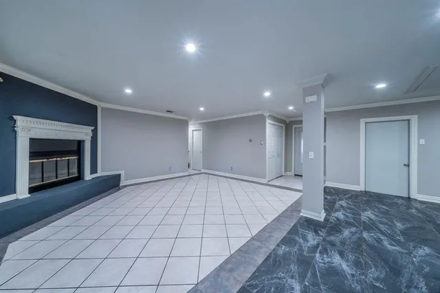 a view of an empty room with a fireplace