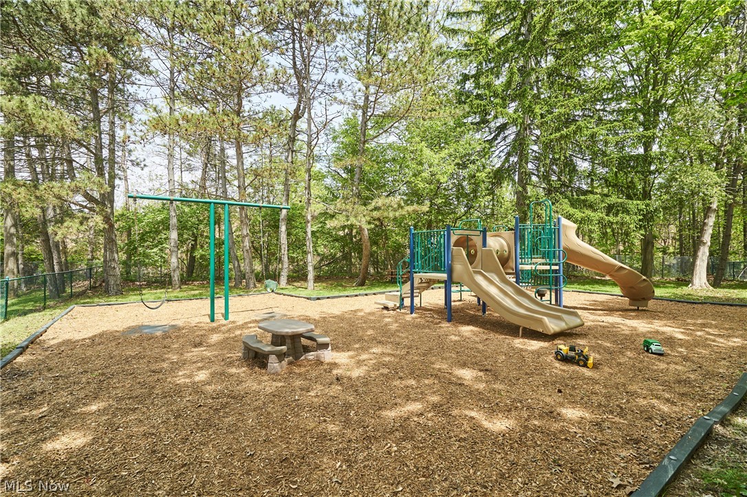 780 Bates Road Rocky River, OH 44116 - Photo 34 of 35 Dedicated playground area featuring a multi-slide play structure, swing set, and a stone picnic table