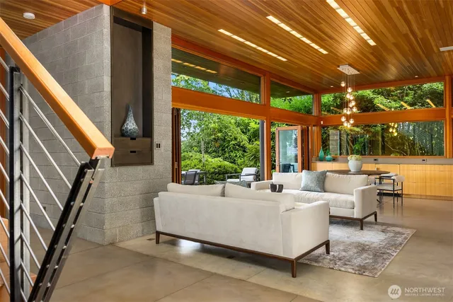 a living room with patio furniture and a floor to ceiling window
