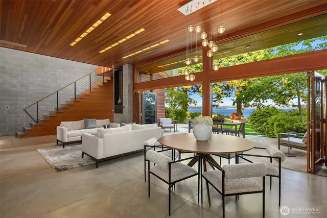 a living room with patio furniture and a floor to ceiling window