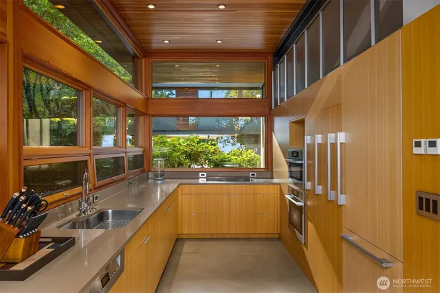 a view of a balcony with chairs and a potted plant