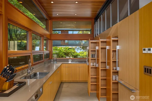 a dining room with glass windows and table