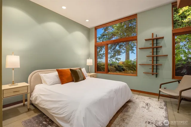 a bathroom with a tub a sink and mirror