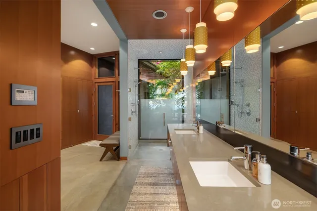 a bathroom with a double vanity sink and a large mirror