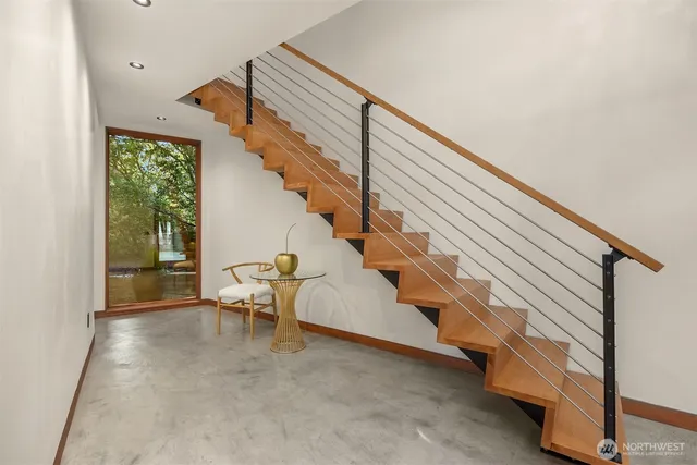 a living room with furniture a mirror and a wooden floors