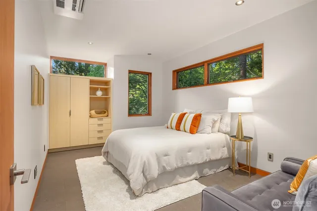 a bedroom with a bed and a painting on the wall