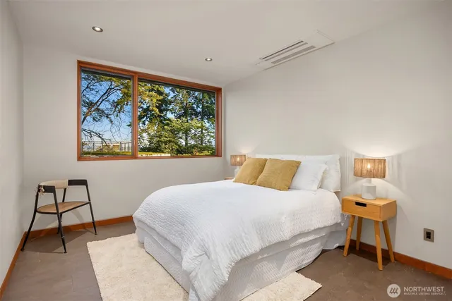 a bedroom with a bed and a mirror