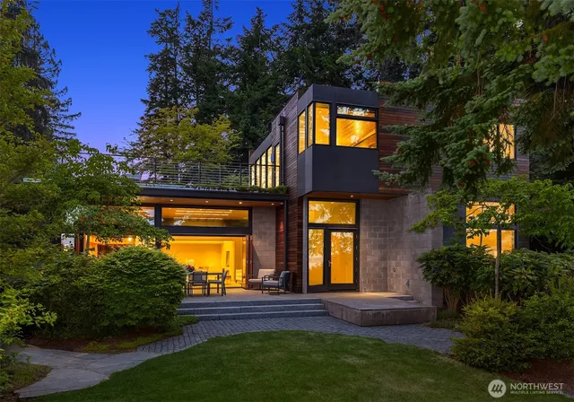 a view of house with a swimming pool and garden