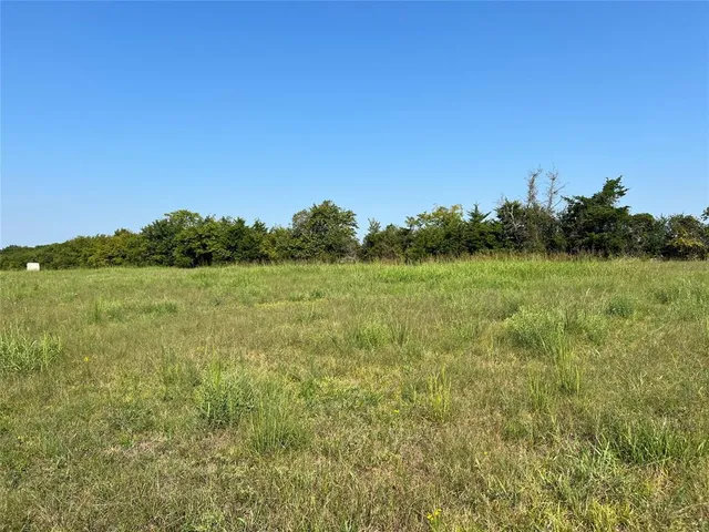 a view of a lake with houses in the back